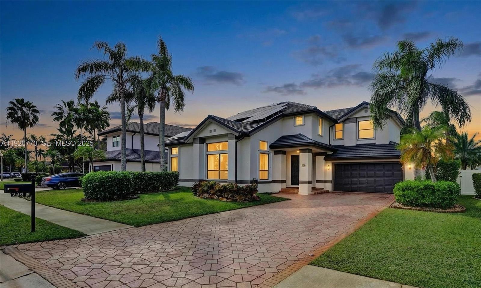 740 Cypress Pointe Drive East Pembroke Pines, FL 33027 - Photo 43 of 46 a front view of house with yard and green space