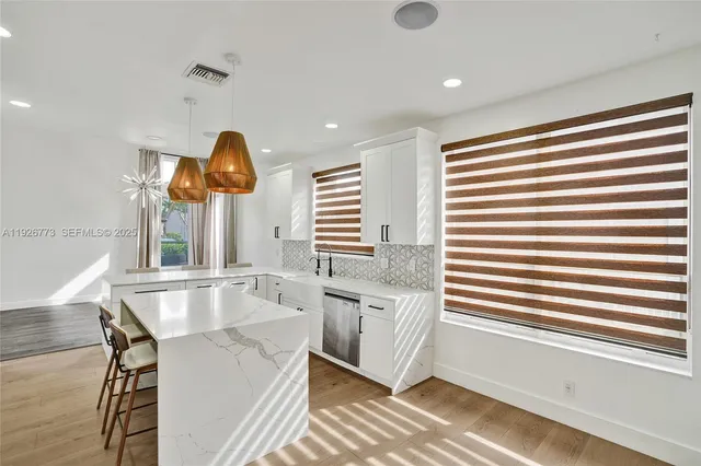 a kitchen with stainless steel appliances granite countertop a sink and a window
