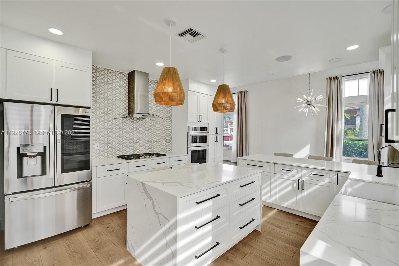 740 Cypress Pointe Drive East Pembroke Pines, FL 33027 - Photo 9 of 46 a kitchen with stainless steel appliances granite countertop a sink and a stove