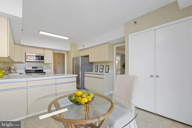 a dining room with furniture and a floor to ceiling window