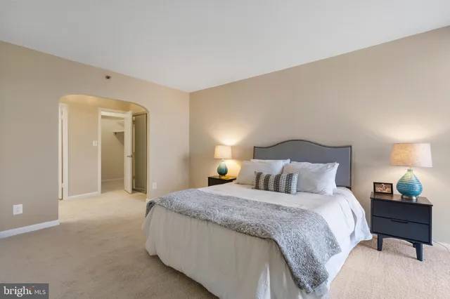 a bedroom with a bed and a lamp