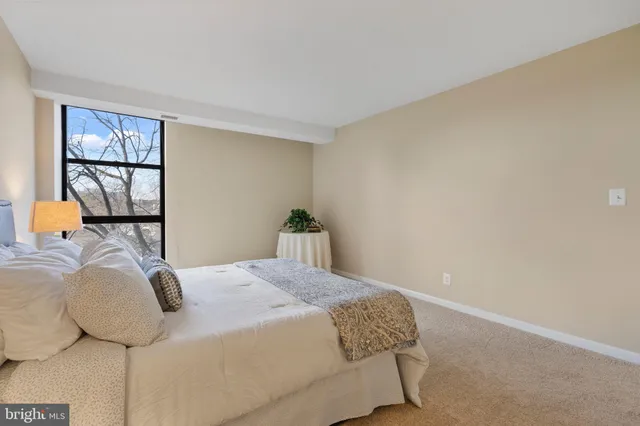 a bedroom with a bed and a lamp