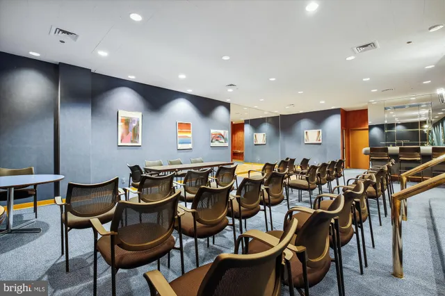a reading room with furniture book shelf and wooden floor