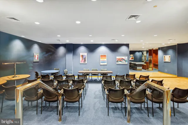 a lobby with furniture and a rug