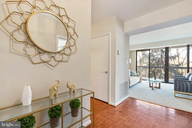 a picture of a wall with a white bed and a painting on the wall