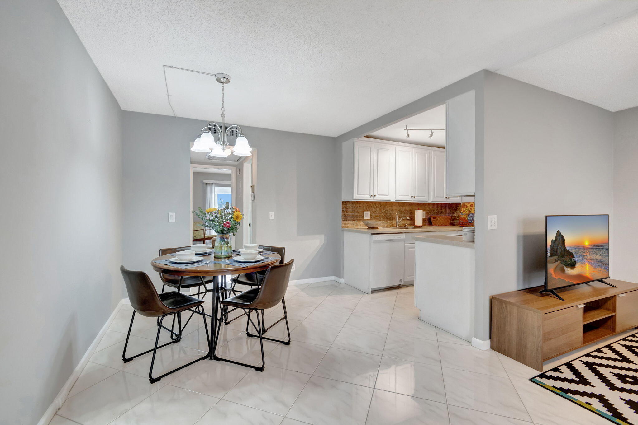 3031 Cornwall East Boca Raton, FL 33434 - Photo 7 of 84 a view of a dining room with furniture and chandelier