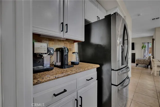 a kitchen with white cabinets and appliances
