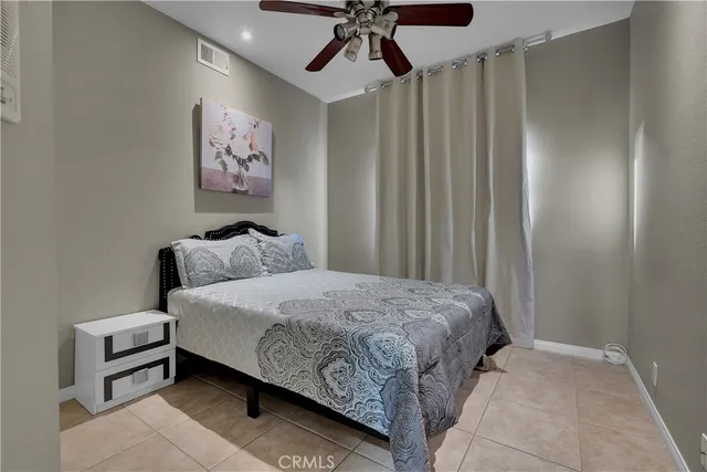 a balcony with wooden floor table and chairs