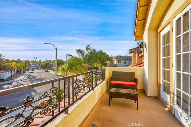 a view of a balcony dining table and chairs