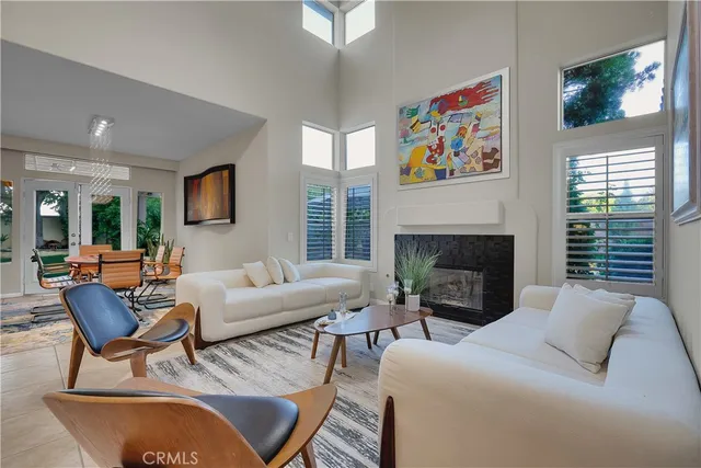 a living room with furniture a fireplace and a large mirror