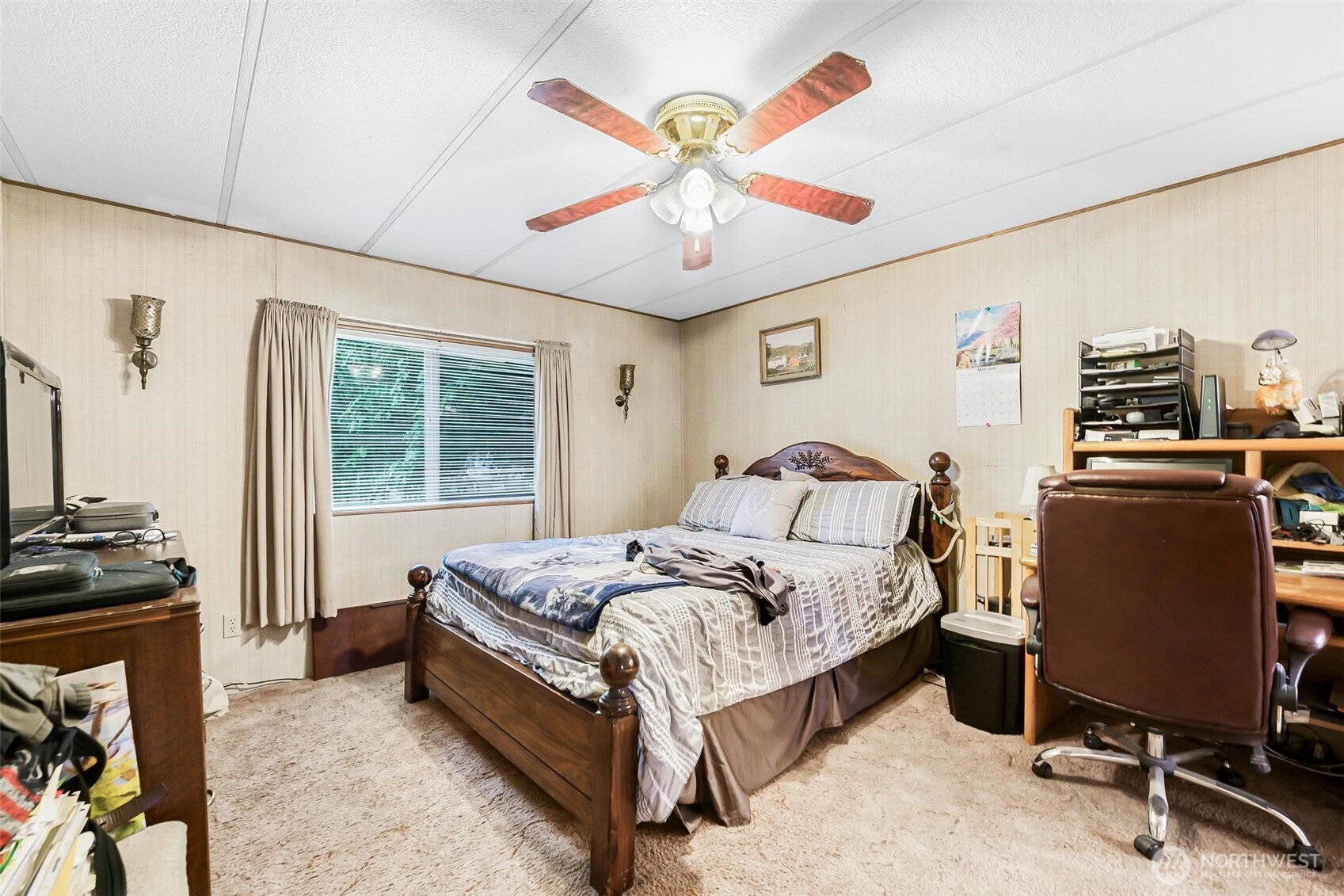 980 South Falcon Road Camano Island, WA 98282 - Photo 12 of 30 a spacious bedroom with a bed and a chandelier