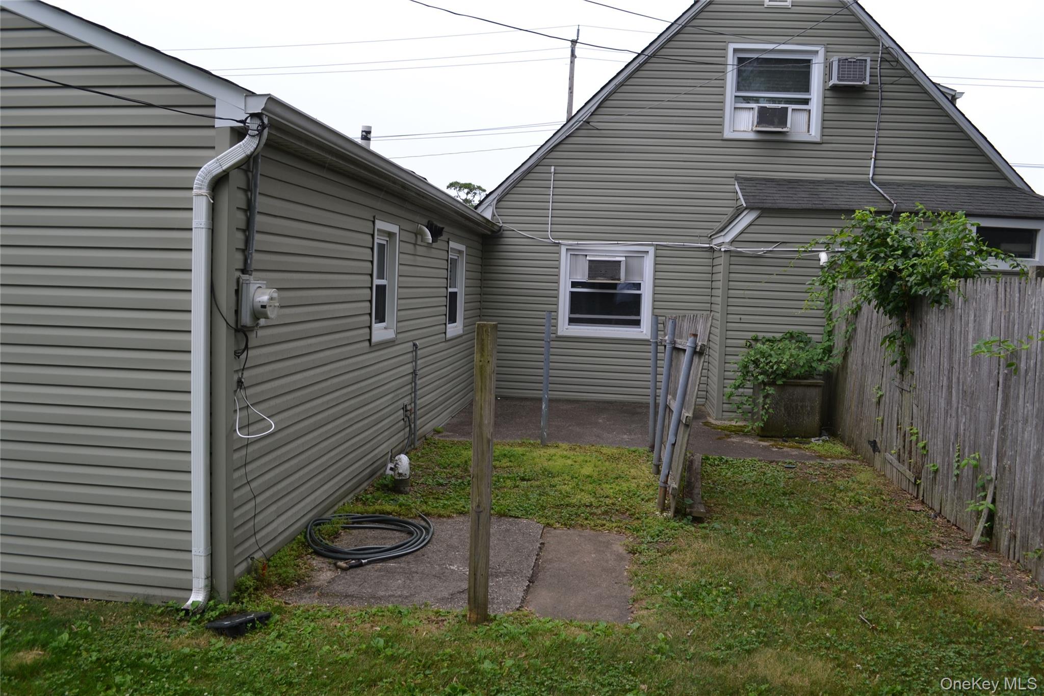 516 Long Beach Road Island Park, NY 11558 - Photo 14 of 31 rear of house showing connection wall.