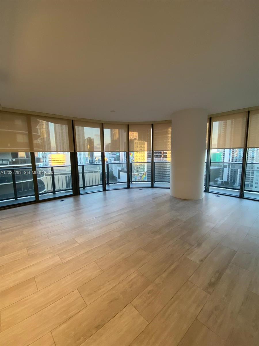 55 Southwest 9th Street, Unit 1503 Miami, FL 33130 - Photo 2 of 11 wooden floor in an empty room with a window