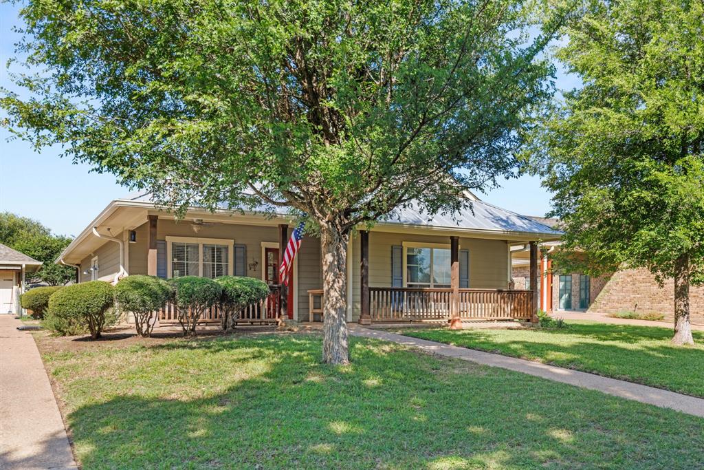 10609 Aquilla Trail Waco, TX 76708 - Photo 3 of 30 Single-story residence featuring a covered front porch with wood-finish railing and columns, light-colored siding, and a metal roof