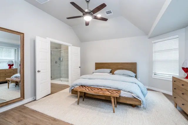 a bedroom with a bed and a chandelier
