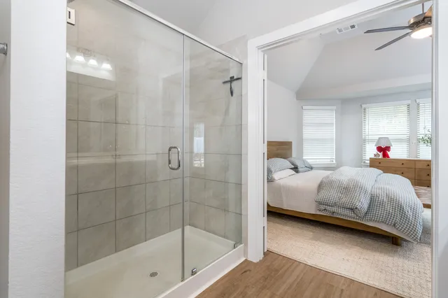 a bedroom with a bed and a mirror