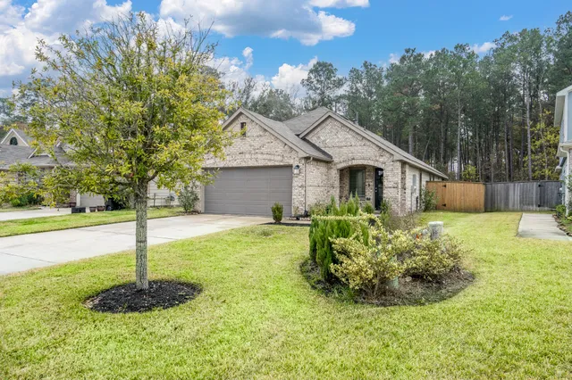 a front view of house with yard and green space