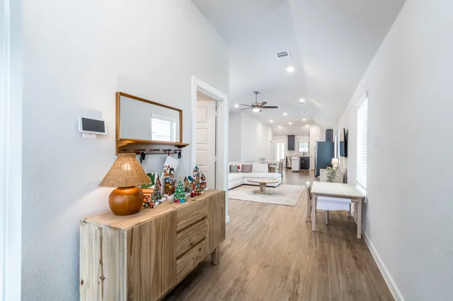 a bedroom with furniture and a wooden floor