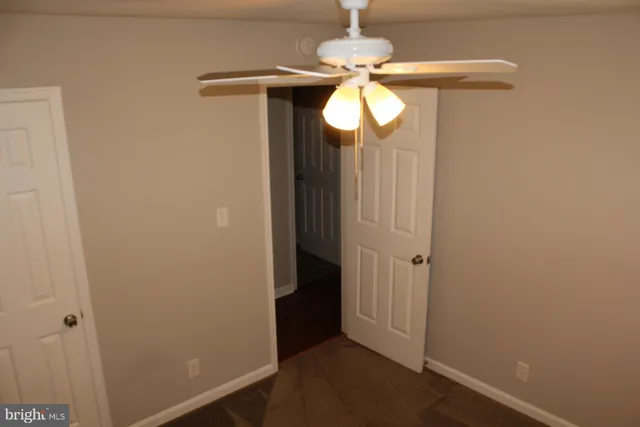 a view of house with wooden stairs and a small yard
