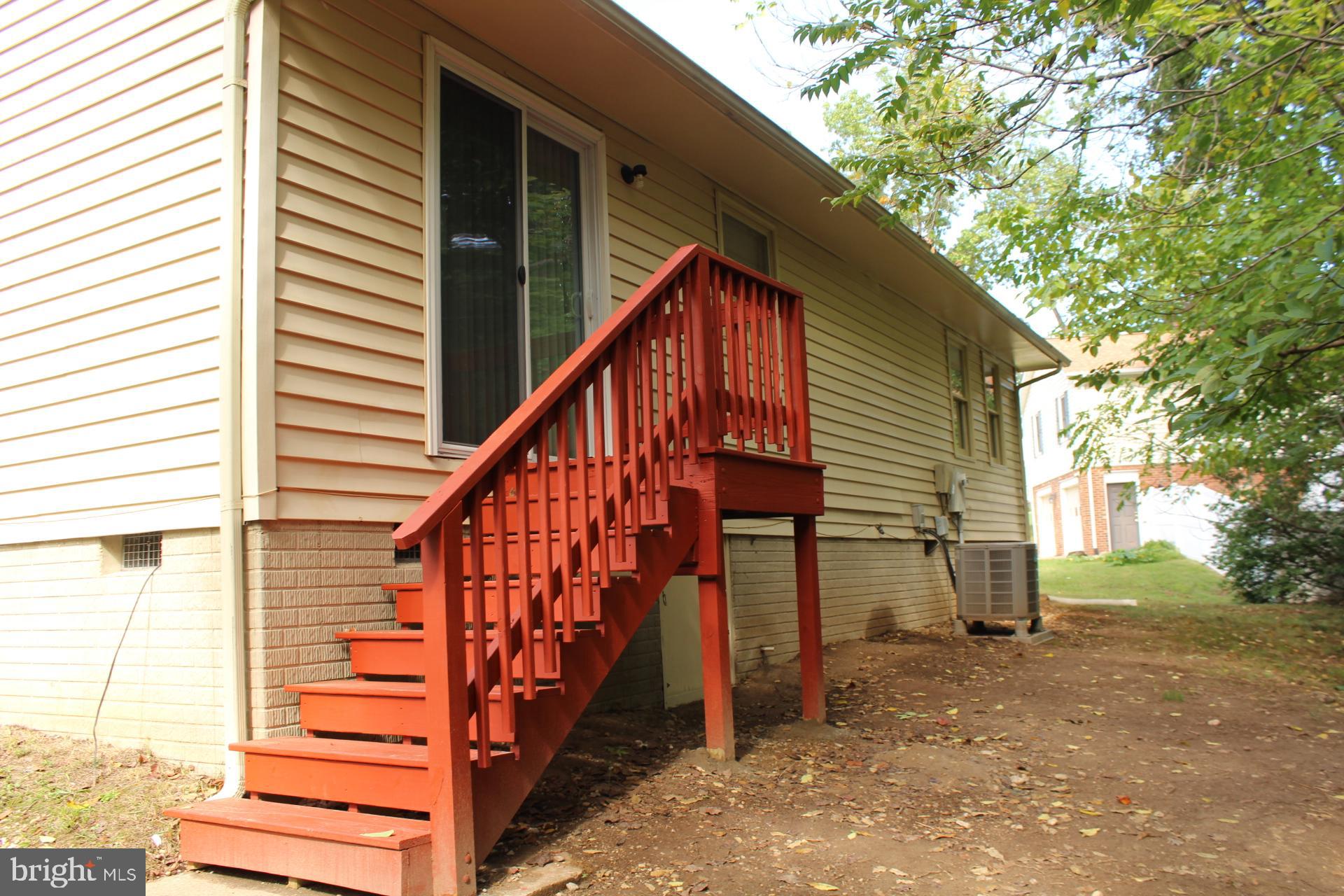 423 Laurel Avenue Fredericksburg, VA 22408 - Photo 27 of 28 a view of house with wooden stairs and a small yard