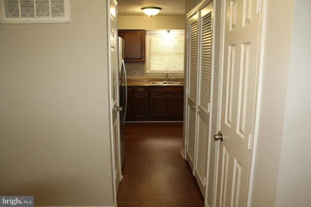 a view of a kitchen from a hallway