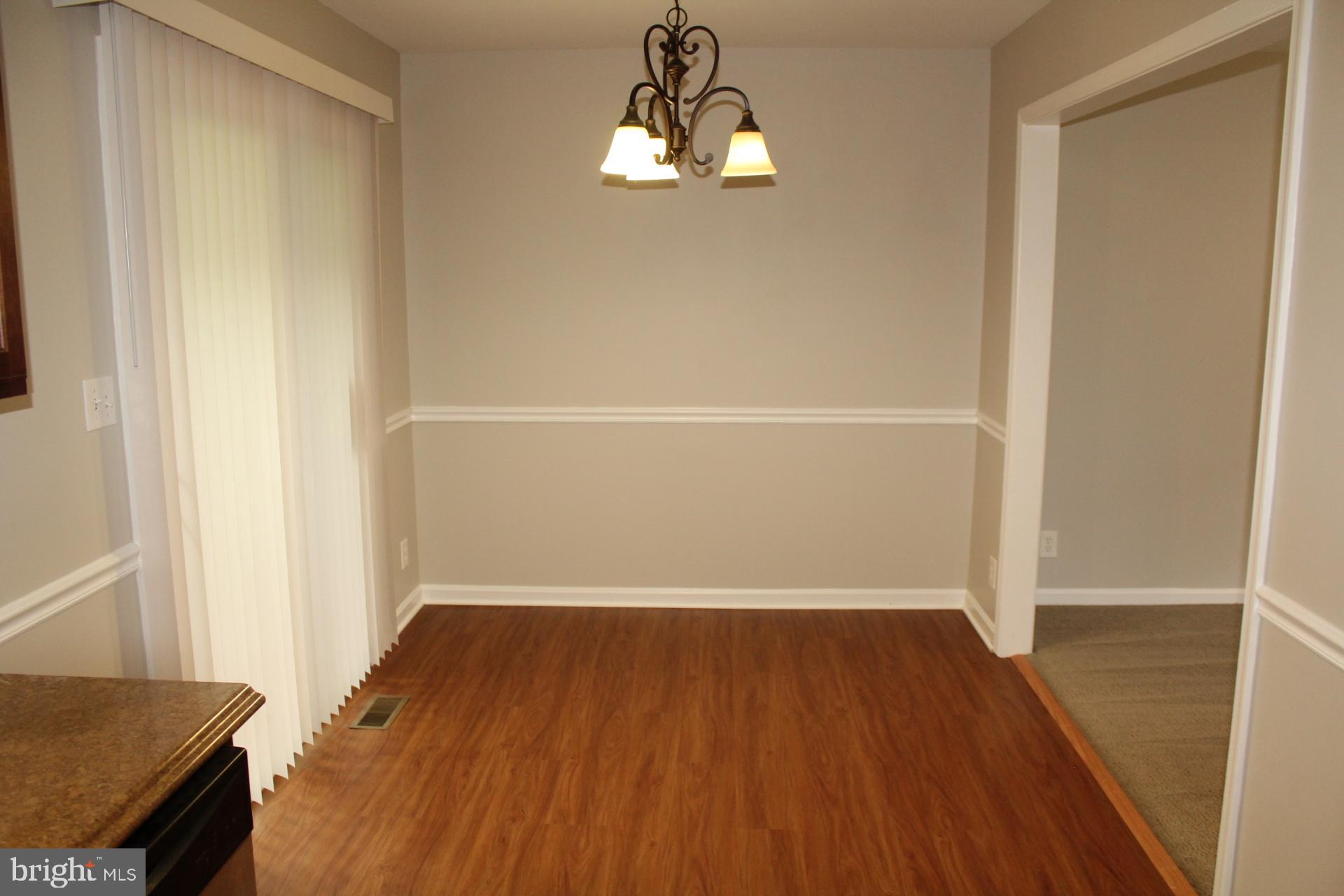 423 Laurel Avenue Fredericksburg, VA 22408 - Photo 7 of 28 an empty room with wooden floor and windows