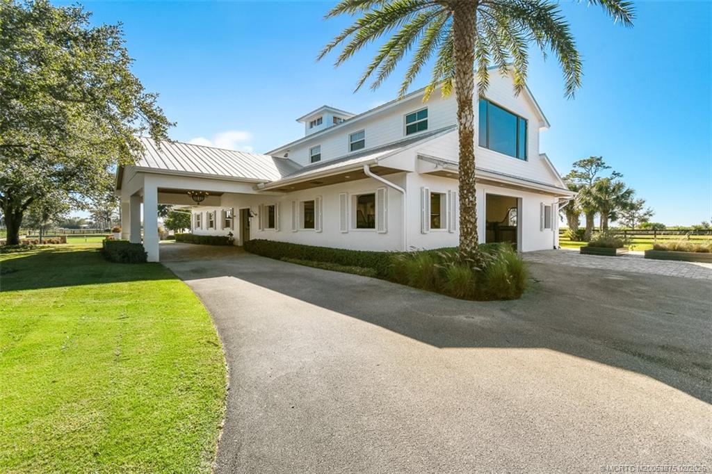 2541 Southwest Trailside Path Stuart, FL 34997 - Photo 6 of 100 a front view of a house with a yard and trees