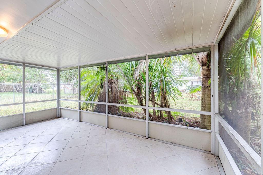 835 5th Street Port Orange, FL 32129 - Photo 15 of 17 a view of an empty room with wooden floor and iron stairs
