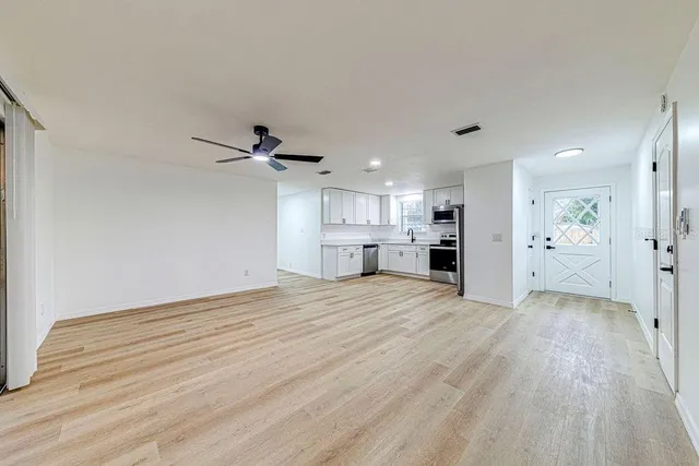 a view of a kitchen with a sink and a refrigerator