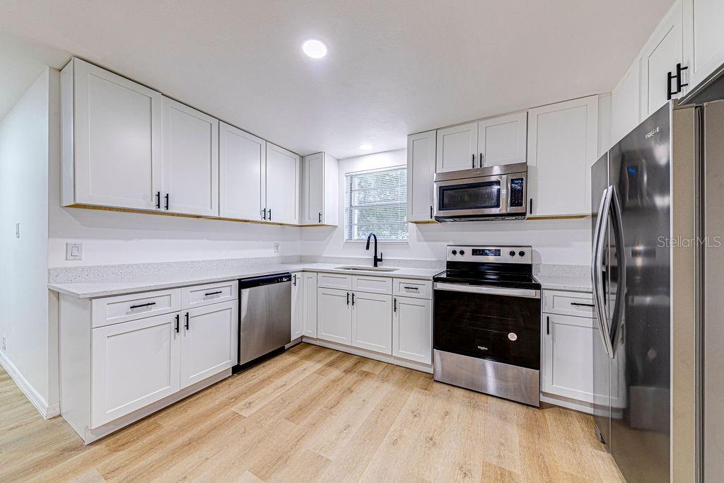 835 5th Street Port Orange, FL 32129 - Photo 4 of 17 a kitchen with granite countertop a refrigerator stove and sink