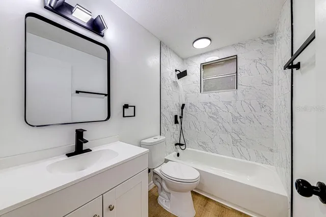 a bathroom with a sink a toilet and a tub