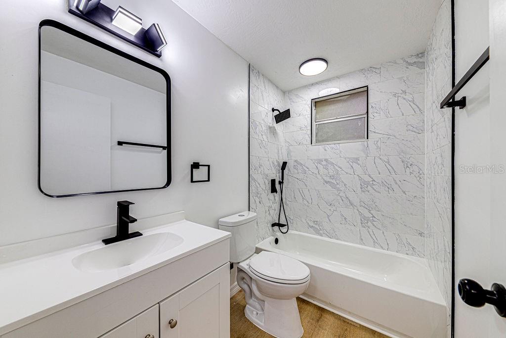 835 5th Street Port Orange, FL 32129 - Photo 6 of 17 a bathroom with a sink a toilet and a tub