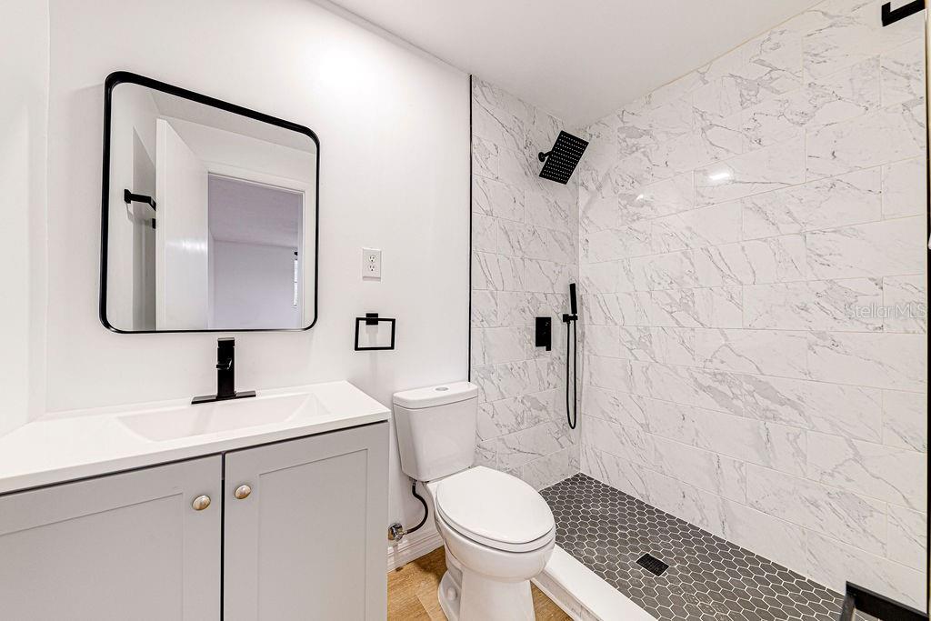 835 5th Street Port Orange, FL 32129 - Photo 9 of 17 a bathroom with a toilet sink and mirror