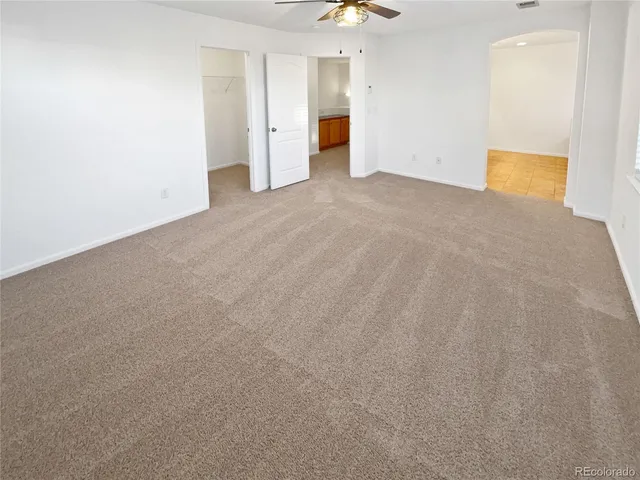 a view of an empty room with a kitchen