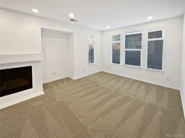 a view of an empty room with a fireplace