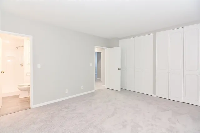 a view of an empty room and a bathroom