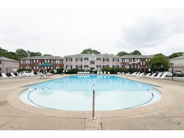 an aerial view of a building with outdoor space and street view