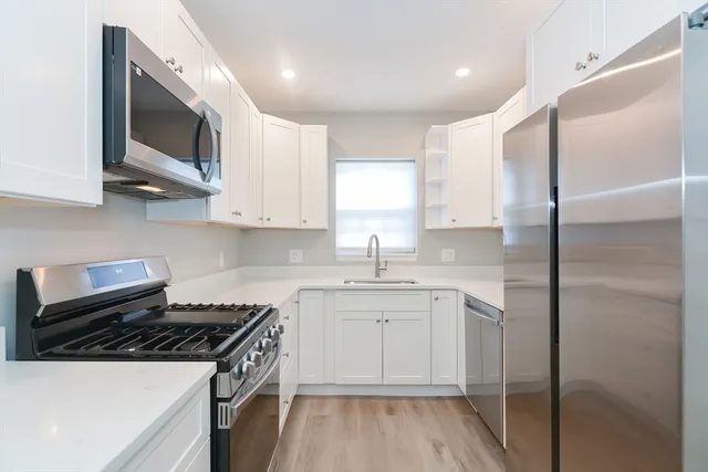 a kitchen with a sink stove and microwave