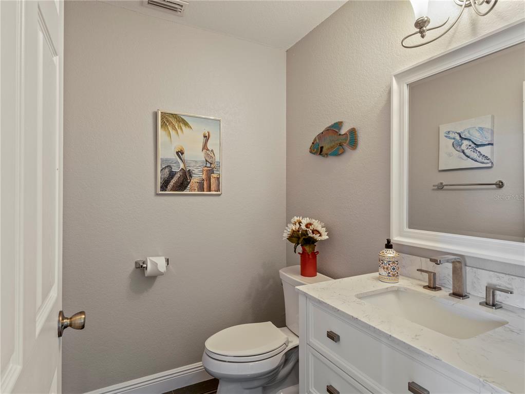 20 Fort Clinch Heights Road Frostproof, FL 33843 - Photo 14 of 38 a bathroom with a toilet a sink and mirror