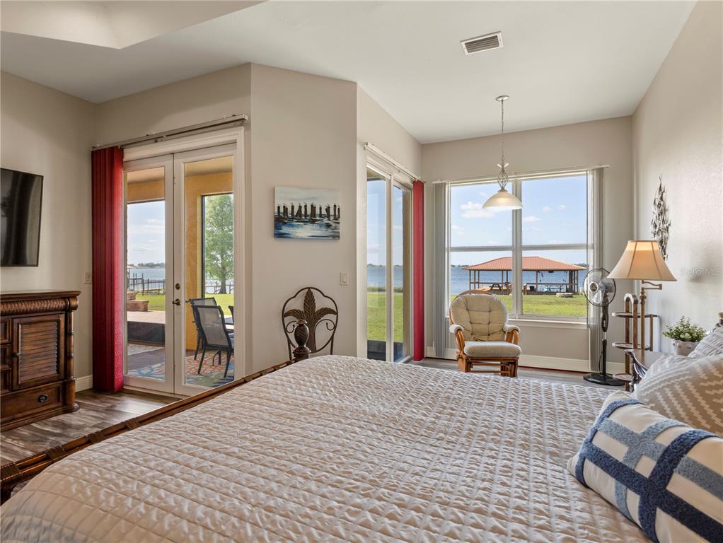 20 Fort Clinch Heights Road Frostproof, FL 33843 - Photo 15 of 38 a bedroom with a bed large window and table chair