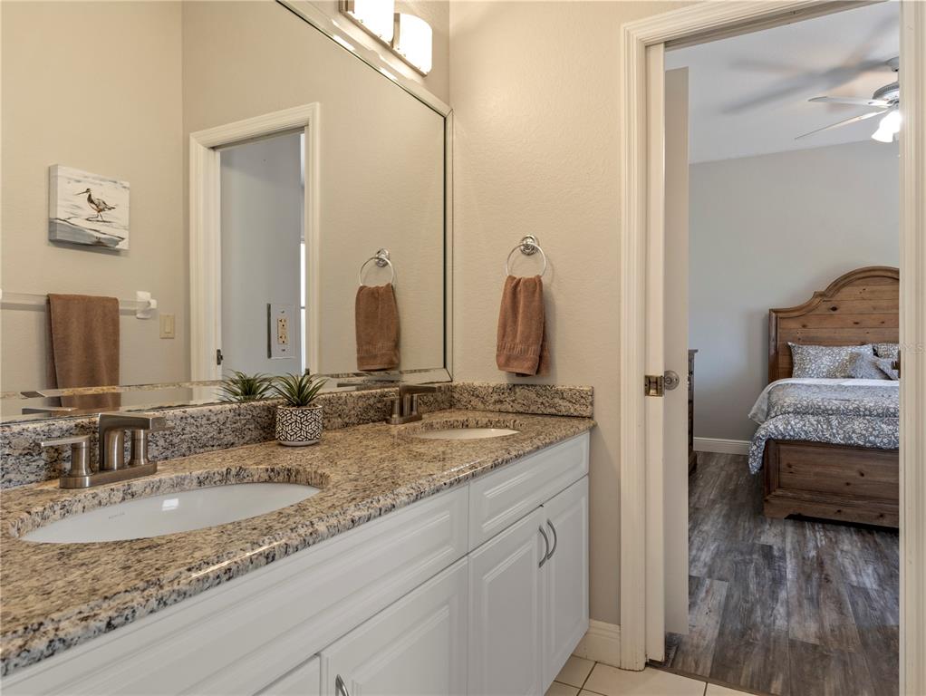 20 Fort Clinch Heights Road Frostproof, FL 33843 - Photo 25 of 38 a en suite bathroom with a granite countertop sink and a mirror