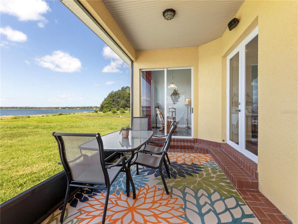 20 Fort Clinch Heights Road Frostproof, FL 33843 - Photo 29 of 38 a view of a balcony with table and chairs