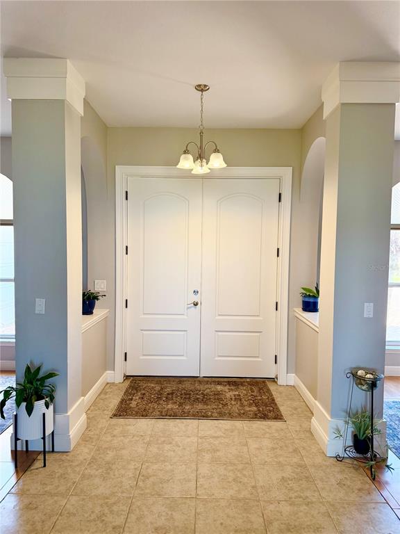 20 Fort Clinch Heights Road Frostproof, FL 33843 - Photo 5 of 38 a view of a hallway with potted plants in front of door