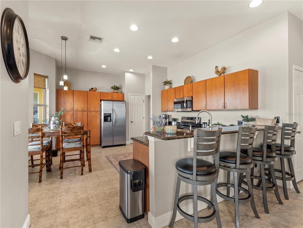 20 Fort Clinch Heights Road Frostproof, FL 33843 - Photo 8 of 38 a kitchen with stainless steel appliances kitchen island granite countertop a table and chairs in it