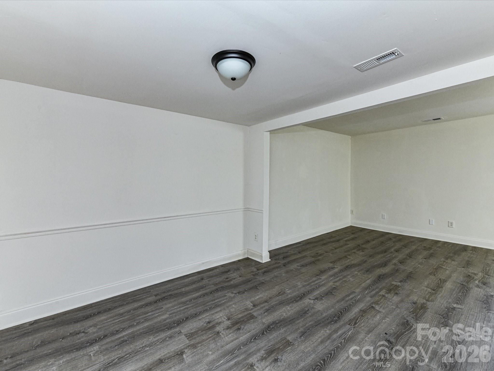8322 Knights Bridge Road Charlotte, NC 28210 - Photo 14 of 37 a view of an empty room with wooden floor