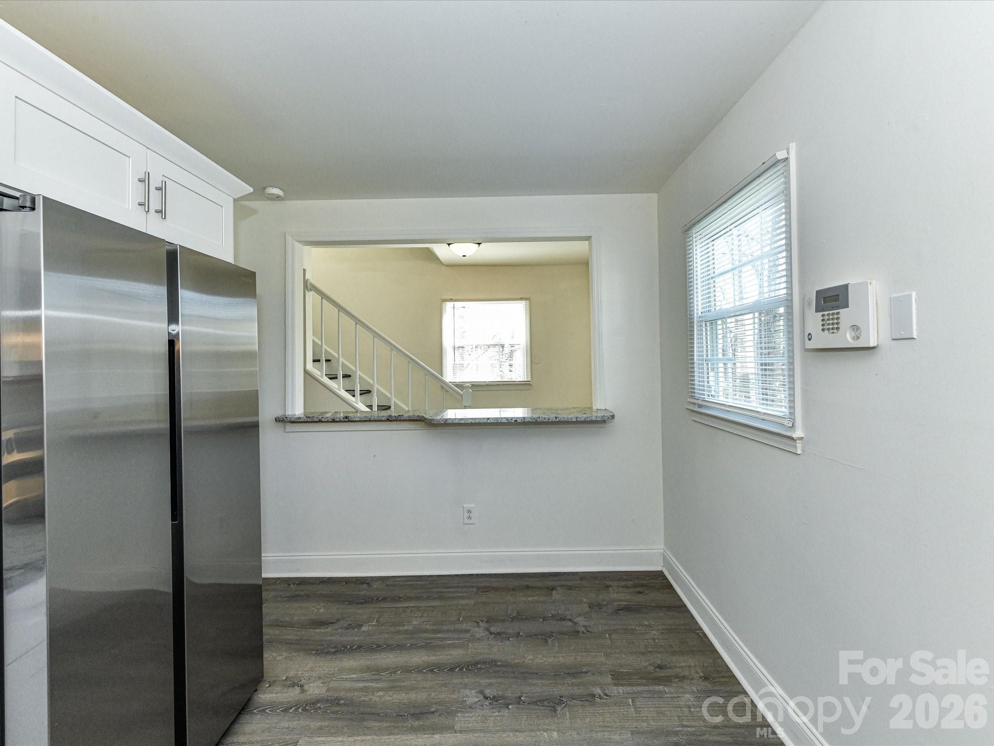 8322 Knights Bridge Road Charlotte, NC 28210 - Photo 19 of 37 a view of empty room with wooden floor and fan