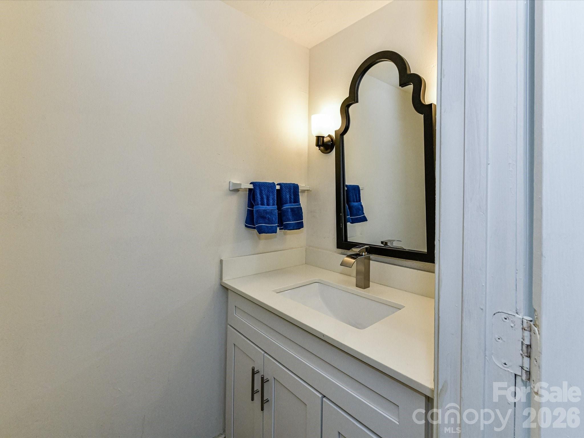 8322 Knights Bridge Road Charlotte, NC 28210 - Photo 20 of 37 a bathroom with a sink and a mirror