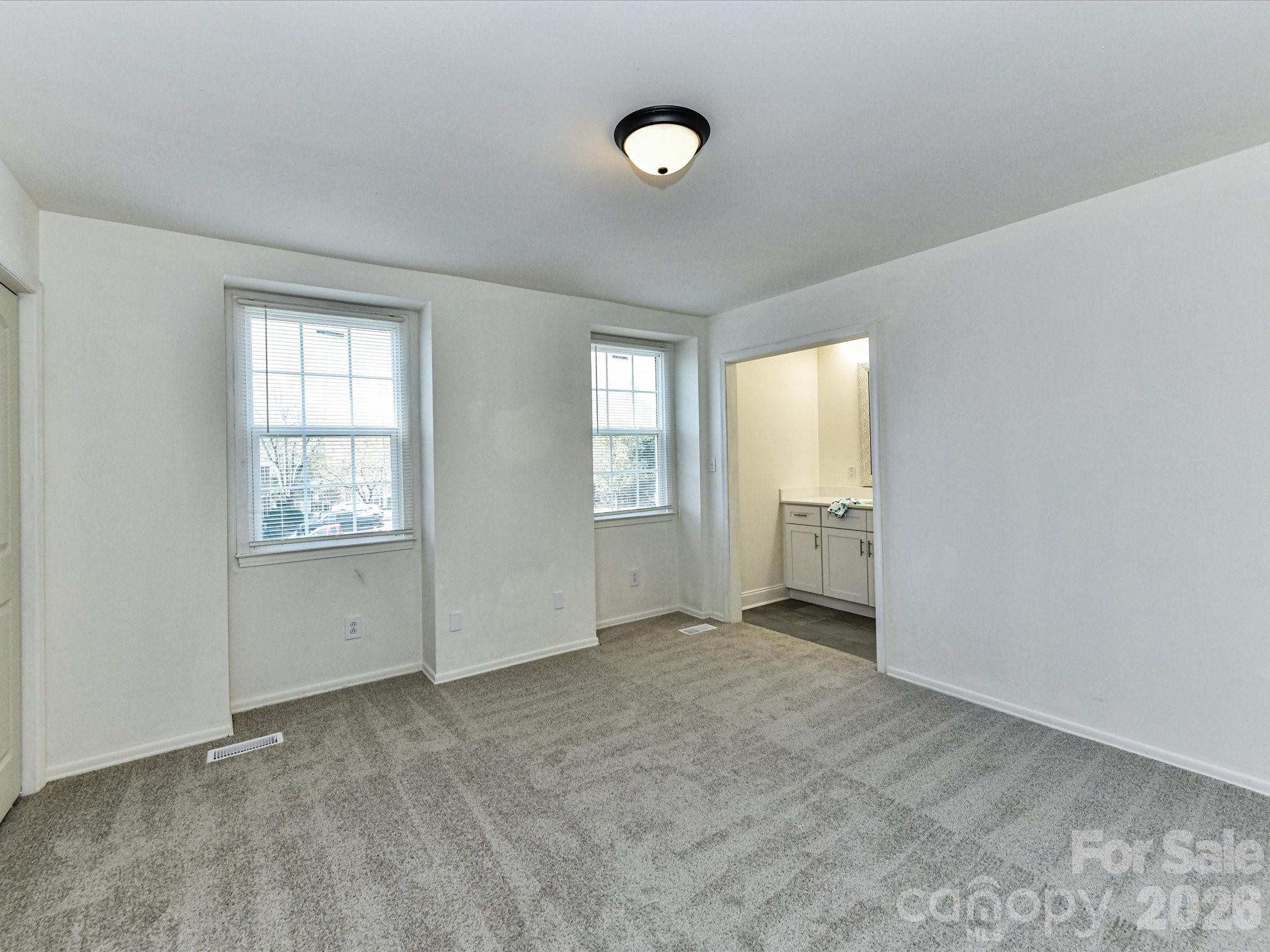 8322 Knights Bridge Road Charlotte, NC 28210 - Photo 23 of 37 an empty room with windows and cabinet