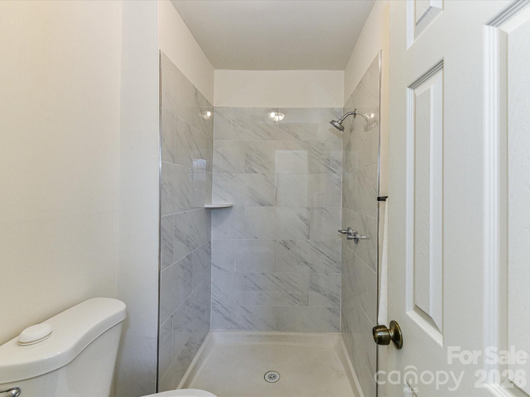 8322 Knights Bridge Road Charlotte, NC 28210 - Photo 27 of 37 a bathroom with a shower a toilet and sink
