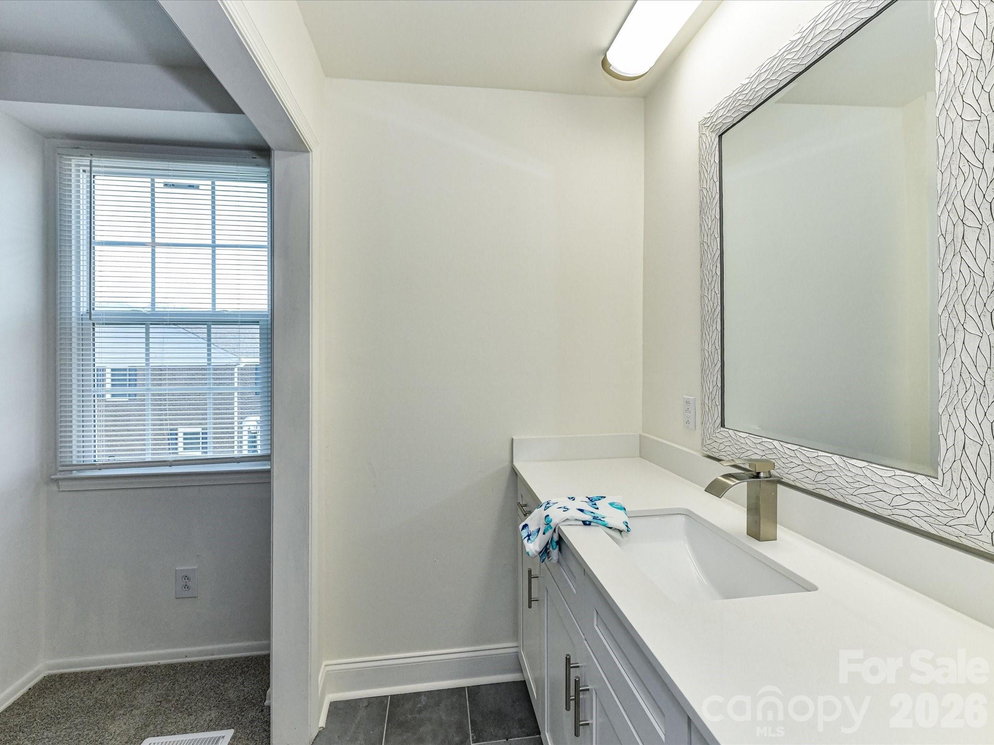 8322 Knights Bridge Road Charlotte, NC 28210 - Photo 28 of 37 a bathroom with a sink a vanity and a mirror